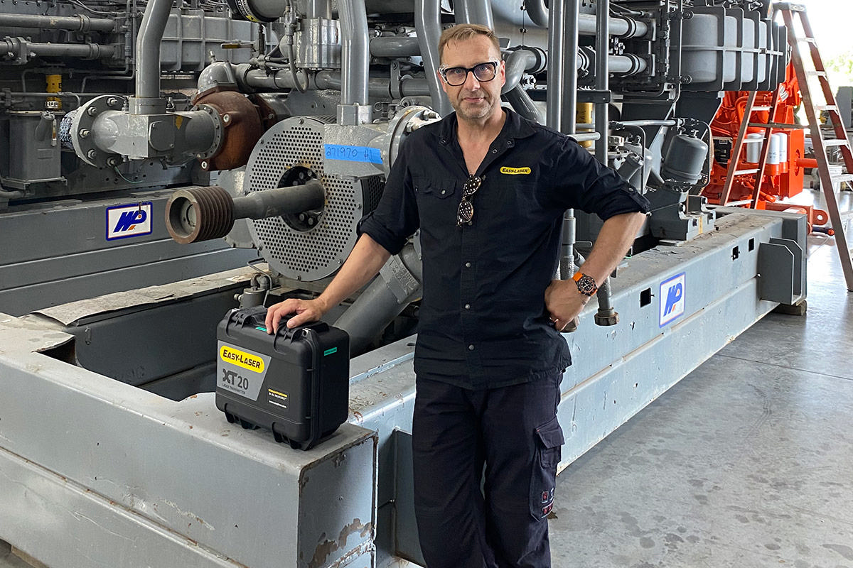 Man standing in front of large compressor