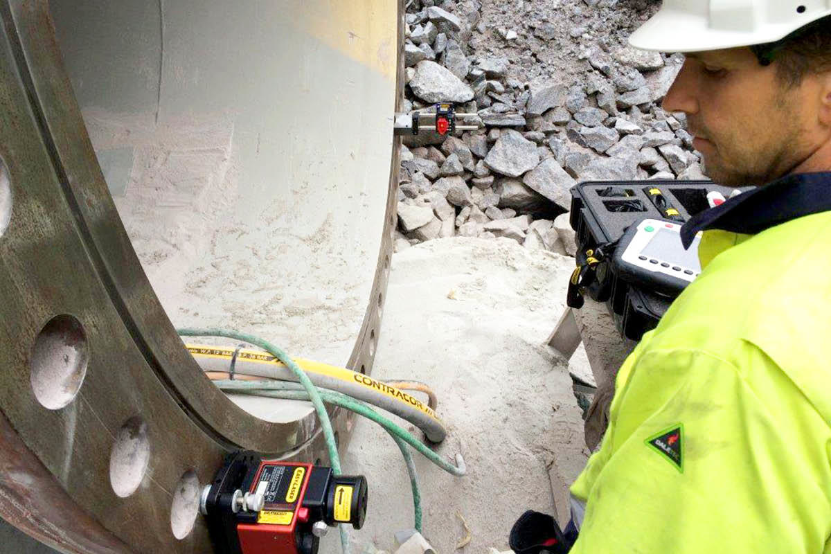 Man next to the inlet flange with measuring equipment
