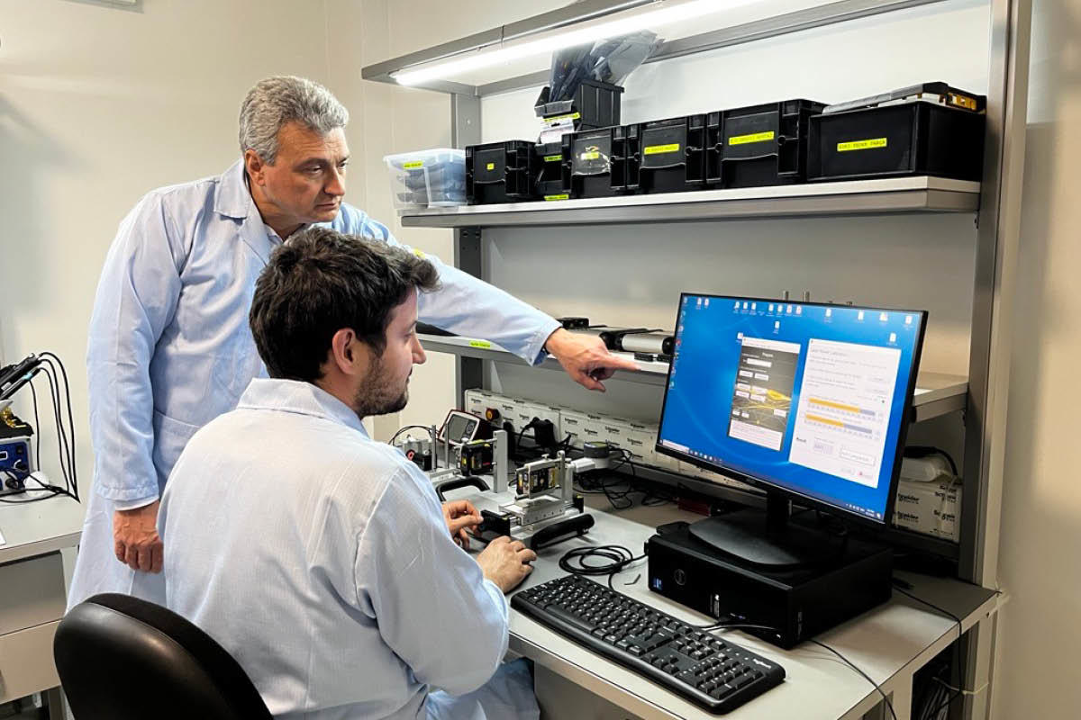 Two men looking at a screen in the service center calibrating a device