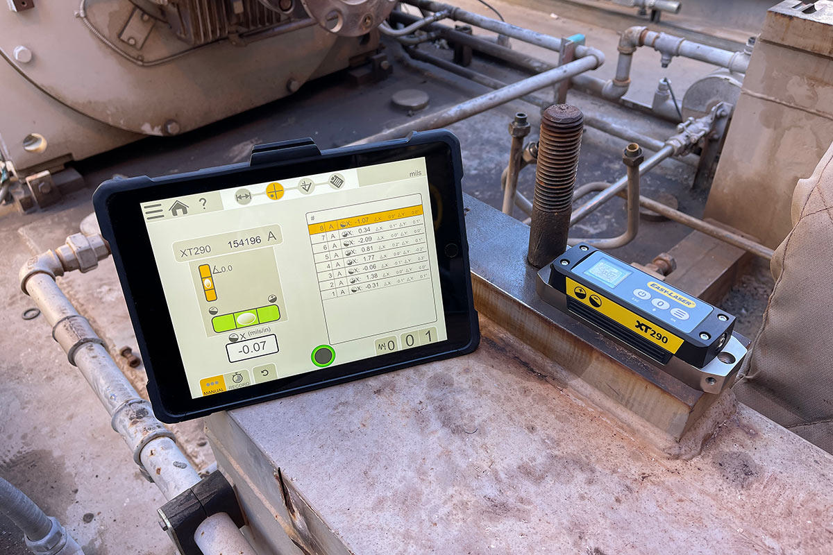 An ipad and a digital level on a machine.